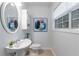 Charming half bath with updated vanity, framed mirror and natural light at 502 Bridge Se Ln, Smyrna, GA 30082