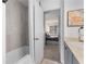 Bright bathroom showing a tub, shower, vanity, and view into an adjacent bedroom at 502 Bridge Se Ln, Smyrna, GA 30082