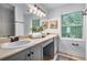 Bright bathroom with double sinks, marble countertops, and a large mirror under a modern light fixture at 502 Bridge Se Ln, Smyrna, GA 30082