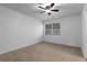Neutral carpeted bedroom with a ceiling fan, and a window with horizontal blinds at 502 Bridge Se Ln, Smyrna, GA 30082