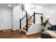 Bright foyer featuring hardwood floors, staircase with dark wood railings, and white doors at 502 Bridge Se Ln, Smyrna, GA 30082