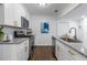 Bright kitchen featuring stainless steel appliances, granite countertops, white cabinets and a view to dining at 502 Bridge Se Ln, Smyrna, GA 30082