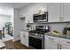 Updated kitchen shows stainless steel appliances, granite countertops, white cabinets, and a view to a breakfast nook at 502 Bridge Se Ln, Smyrna, GA 30082