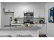 Updated kitchen features stainless steel appliances, white cabinets and granite countertops, perfect for cooking at 502 Bridge Se Ln, Smyrna, GA 30082