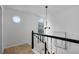 Bright landing features modern chandelier, arched window, and black and white staircase at 502 Bridge Se Ln, Smyrna, GA 30082