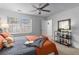 Cozy bedroom with a ceiling fan, window with blinds, and a comfortable bed with pillows and blankets at 502 Bridge Se Ln, Smyrna, GA 30082