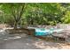 View of a community pool with tables and chairs on a sunny day at 502 Bridge Se Ln, Smyrna, GA 30082