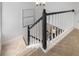Carpeted staircase featuring a black and white banister with a neutral-toned abstract painting on the wall at 502 Bridge Se Ln, Smyrna, GA 30082