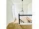 Bright landing features modern chandelier, large arched window, and black and white staircase at 502 Bridge Se Ln, Smyrna, GA 30082