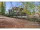 Rear view of a home showcasing the backyard and its relationship to the surrounding wooded landscape at 5861 Community Rd, Mableton, GA 30126