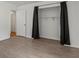 Spacious bedroom with wood-look flooring, closet, and black-out curtains at 5861 Community Rd, Mableton, GA 30126