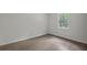 Cozy bedroom with wood-look flooring, natural light, and neutral walls at 5861 Community Rd, Mableton, GA 30126
