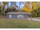 Charming single-story home featuring a covered front porch and well-manicured front lawn, ideal for suburban living at 5861 Community Rd, Mableton, GA 30126