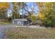 Quaint single-Gathering home with a driveway, showcasing a well-maintained exterior and natural surroundings at 5861 Community Rd, Mableton, GA 30126