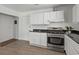 Kitchen with stainless steel oven, granite countertops and white cabinetry at 5861 Community Rd, Mableton, GA 30126