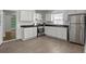 Bright kitchen featuring stainless appliances, granite counters and tile flooring at 5861 Community Rd, Mableton, GA 30126