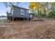 View of the elevated rear of a house, showing the deck and the surrounding landscape in a rural setting at 5861 Community Rd, Mableton, GA 30126