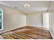 Bedroom featuring hardwood flooring, a ceiling light, and a light beige wall at 6211 Ward Rd, Union City, GA 30291