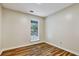 Bedroom featuring wood-look floors and a window with security bars at 6211 Ward Rd, Union City, GA 30291
