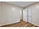 Bright bedroom featuring wood-look floors, neutral paint, and closet with double doors at 6211 Ward Rd, Union City, GA 30291