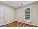 Bedroom with wood-look floors and a window with security bars at 6211 Ward Rd, Union City, GA 30291