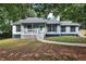 Charming single-story home featuring a cozy front porch and traditional blue siding at 6211 Ward Rd, Union City, GA 30291