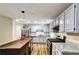 Modern kitchen featuring stainless steel appliances, granite countertops, and stylish lighting at 6211 Ward Rd, Union City, GA 30291
