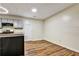 Open kitchen area with grey cabinetry, laminate floors, and modern fixtures at 6211 Ward Rd, Union City, GA 30291