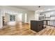 Open layout showing the kitchen and living area, featuring laminate flooring throughout at 6211 Ward Rd, Union City, GA 30291
