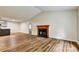 Bright living room featuring a wood-burning fireplace and laminate floors at 6211 Ward Rd, Union City, GA 30291