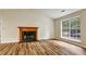 Cozy living room with a fireplace and large window offering ample natural light at 6211 Ward Rd, Union City, GA 30291
