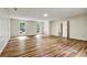 Hardwood flooring is a focal point of this expansive living area with multiple windows at 6211 Ward Rd, Union City, GA 30291