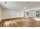 Spacious living room featuring hardwood flooring and natural light from the two large windows at 6211 Ward Rd, Union City, GA 30291
