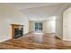 Bright living room with laminate floors, a fireplace, and a view of the front entrance at 6211 Ward Rd, Union City, GA 30291
