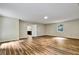 Bright living room with hardwood floors and a door that leads to the kitchen at 6211 Ward Rd, Union City, GA 30291