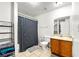 Bright bathroom featuring a shower-tub, toilet, vanity with sink, tile flooring, and a linen rack at 2323 Wingfoot Pl, Decatur, GA 30035