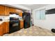 The cozy kitchen features black appliances, tile flooring, and wooden cabinets at 2323 Wingfoot Pl, Decatur, GA 30035