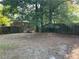 Large, fenced backyard with mature trees, providing ample space and privacy for outdoor activities at 33 Drew Ct, Jonesboro, GA 30238