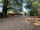 A spacious backyard with mature trees and a patio door, perfect for outdoor living and entertainment at 33 Drew Ct, Jonesboro, GA 30238
