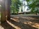 Expansive backyard featuring mature trees and a patio door, ideal for relaxation and outdoor enjoyment at 33 Drew Ct, Jonesboro, GA 30238