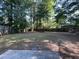 Large backyard with tall trees and ample space, perfect for outdoor activities and gardening at 33 Drew Ct, Jonesboro, GA 30238