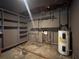 Unfinished basement with shelving and utilities, offering potential for customization and extra storage at 33 Drew Ct, Jonesboro, GA 30238