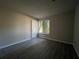 A cozy bedroom features light-grey walls, a window that provides natural light, and wood-look flooring at 33 Drew Ct, Jonesboro, GA 30238