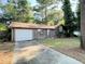 A single story home with brown siding and a one car garage at 33 Drew Ct, Jonesboro, GA 30238