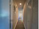 A narrow hallway featuring wood-look flooring connects various rooms, enhancing the flow of the home at 33 Drew Ct, Jonesboro, GA 30238