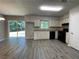An eat-in kitchen with white cabinets, black appliances and a sliding glass door to the backyard at 33 Drew Ct, Jonesboro, GA 30238