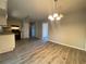 An eat-in kitchen with white cabinets, black appliances and modern floors at 33 Drew Ct, Jonesboro, GA 30238