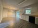 An eat-in kitchen with white cabinets, black appliances and a sliding glass door to the backyard at 33 Drew Ct, Jonesboro, GA 30238