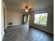 A living room with hardwood floors, a ceiling fan, neutral paint and a view to the front yard at 33 Drew Ct, Jonesboro, GA 30238