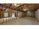 Unfinished basement with exposed wood frame and concrete walls, presenting a versatile space for future development at 504 Iris Way, Villa Rica, GA 30180